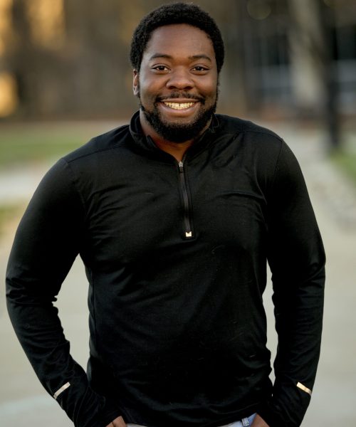 vertical-shot-attractive-african-american-male-smiling-camera-min